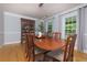 Formal dining room with hardwood floors, elegant china cabinet, and large windows, ideal for entertaining at 2249 Hill Creek Way, Marietta, GA 30062