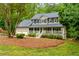 A charming two-story home featuring a welcoming front porch, two-car garage and a well-maintained front yard at 2249 Hill Creek Way, Marietta, GA 30062