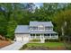 Charming two-story home with a welcoming front porch and attached two-car garage surrounded by lush trees at 2249 Hill Creek Way, Marietta, GA 30062