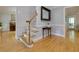 Elegant foyer with hardwood floors, staircase, and decorative mirror creating a welcoming entrance at 2249 Hill Creek Way, Marietta, GA 30062