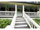 Inviting front porch with stairs, decorative plants, and white railings leading to the front door at 2249 Hill Creek Way, Marietta, GA 30062