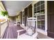 Cozy front porch with a rocking chair, decorative pillows, and hanging plants, perfect for relaxation at 2249 Hill Creek Way, Marietta, GA 30062