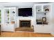 Bright living room featuring custom built-ins flanking a fireplace and large screen TV at 2249 Hill Creek Way, Marietta, GA 30062