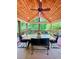 Covered porch with exposed wood ceiling, ceiling fan, and an outdoor dining table with comfortable seating at 2249 Hill Creek Way, Marietta, GA 30062