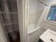 Classic bathroom with a shower-tub combo, shelving and window at 2463 Briarmoor Ne Rd, Atlanta, GA 30345