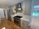 Modern kitchen with stainless steel appliances, stylish backsplash, and hardwood floors at 2463 Briarmoor Ne Rd, Atlanta, GA 30345