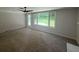 Spacious living room with a brick wall, ceiling fan, and a door leading to the backyard at 2463 Briarmoor Ne Rd, Atlanta, GA 30345