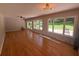 Sunlit living room featuring hardwood floors and large windows overlooking the backyard at 2463 Briarmoor Ne Rd, Atlanta, GA 30345