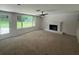 Bright living room featuring a fireplace, ceiling fan, and a large window overlooking the backyard at 2463 Briarmoor Ne Rd, Atlanta, GA 30345