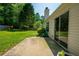 The backyard patio with sliding glass doors to the house and green grass at 648 Bellingham Dr, Sugar Hill, GA 30518
