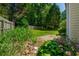 View of the backyard featuring grass, foliage, a fence, and a patio at 648 Bellingham Dr, Sugar Hill, GA 30518