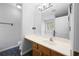 Bathroom featuring a large mirror, single sink, and wood vanity at 648 Bellingham Dr, Sugar Hill, GA 30518