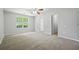 Bedroom with neutral carpet, ceiling fan, and double-hung windows at 648 Bellingham Dr, Sugar Hill, GA 30518