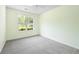 Bedroom with neutral carpet and window views of the yard at 648 Bellingham Dr, Sugar Hill, GA 30518