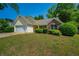 Inviting single-story home with a lush green lawn and mature trees adding to its charm at 648 Bellingham Dr, Sugar Hill, GA 30518