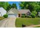 Charming single-story home with manicured lawn, attached garage, and inviting curb appeal at 648 Bellingham Dr, Sugar Hill, GA 30518