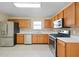 Efficiently designed kitchen features stainless steel appliances, light countertops and ample storage at 648 Bellingham Dr, Sugar Hill, GA 30518