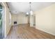Open-concept living space with hardwood flooring, vaulted ceilings and access to kitchen at 648 Bellingham Dr, Sugar Hill, GA 30518