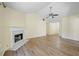Spacious living room featuring vaulted ceilings, fireplace and hardwood flooring at 648 Bellingham Dr, Sugar Hill, GA 30518