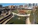 Scenic park view showcasing a pond, walking paths, amphitheater and urban landscape at 648 Bellingham Dr, Sugar Hill, GA 30518