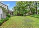 Green backyard with screened porch and mature trees at 870 Richmond Hill Dr, Marietta, GA 30068