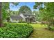 Spacious backyard view of the home with lush greenery and mature trees at 870 Richmond Hill Dr, Marietta, GA 30068