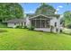 Rear exterior view of home featuring a screened-in porch and large yard at 870 Richmond Hill Dr, Marietta, GA 30068