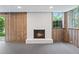 Cozy basement featuring wood paneling, a white brick fireplace, and large windows at 870 Richmond Hill Dr, Marietta, GA 30068