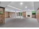 Expansive basement with paneling, columns, and a white brick fireplace at 870 Richmond Hill Dr, Marietta, GA 30068