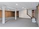 Spacious basement with a finished ceiling, carpet, and support beams at 870 Richmond Hill Dr, Marietta, GA 30068