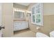 Neutral-toned bathroom featuring white cabinets, granite counters, and shuttered window at 870 Richmond Hill Dr, Marietta, GA 30068