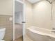 Bathroom featuring a built in tub and shower, and tile walls at 870 Richmond Hill Dr, Marietta, GA 30068