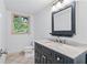 Bathroom with a vanity, marble countertop, dark cabinetry, and tiled floor at 870 Richmond Hill Dr, Marietta, GA 30068