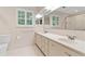 Bathroom with double sinks, white cabinets, and shuttered window at 870 Richmond Hill Dr, Marietta, GA 30068