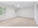 Bedroom featuring neutral carpet, white walls, large windows and closet at 870 Richmond Hill Dr, Marietta, GA 30068