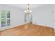 Hardwood floor dining room with plantation shutters and chandelier at 870 Richmond Hill Dr, Marietta, GA 30068