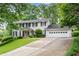 Beautiful two-story home with lush green lawn, mature trees, and a convenient two-car garage at 870 Richmond Hill Dr, Marietta, GA 30068