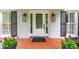 Elegant front door with glass detailing and classic black sconces, framed by lush greenery at 870 Richmond Hill Dr, Marietta, GA 30068