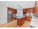Well-lit kitchen features wood cabinets, stainless steel appliances, and kitchen island at 870 Richmond Hill Dr, Marietta, GA 30068