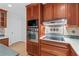 Kitchen with stainless steel oven and microwave, cooktop, and wood cabinets at 870 Richmond Hill Dr, Marietta, GA 30068