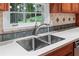 Close up of stainless steel kitchen sink and bright counter and window at 870 Richmond Hill Dr, Marietta, GA 30068