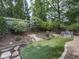 Serene backyard featuring an artificial lawn bordered by landscaping and a wood fence at 1110 Parkview Se Pl, Smyrna, GA 30080
