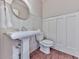 Classic bathroom featuring a pedestal sink, toilet, and wood-look flooring at 1110 Parkview Se Pl, Smyrna, GA 30080