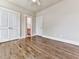Bright bedroom featuring hardwood floors, neutral walls, and double door closet at 1110 Parkview Se Pl, Smyrna, GA 30080