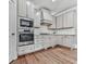 Bright kitchen featuring stainless steel appliances, plenty of cabinet space, and hardwood flooring at 1110 Parkview Se Pl, Smyrna, GA 30080