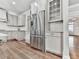 Spacious kitchen with stainless steel refrigerator, shaker cabinets, and seamless access to the living room at 1110 Parkview Se Pl, Smyrna, GA 30080