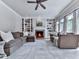 Spacious living room featuring fireplace, large windows, and ceiling fan at 1110 Parkview Se Pl, Smyrna, GA 30080