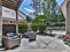 Charming patio area with wicker furniture, grill, and lush landscaping for outdoor enjoyment at 1110 Parkview Se Pl, Smyrna, GA 30080