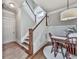Well-lit staircase adjacent to a dining area with hardwood floors and a modern light fixture at 1110 Parkview Se Pl, Smyrna, GA 30080