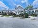 A suburban street scene showcasing a gray two story home with manicured lawn and other neighborhood homes at 1110 Parkview Se Pl, Smyrna, GA 30080